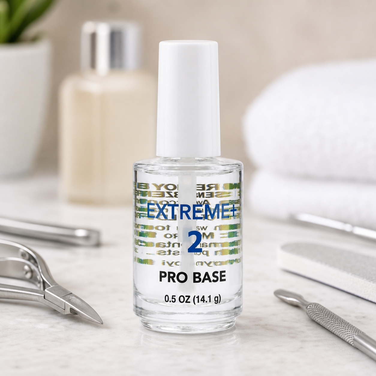 EXTREME+ Step 2 Pro Base bottle on a marble counter with manicure tools and a spa background